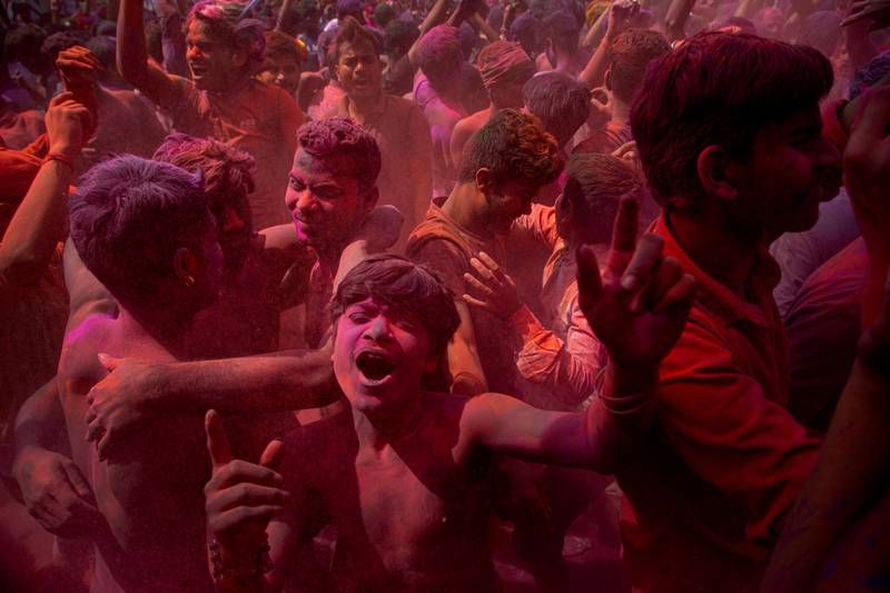Indians dance and throw colored powder during Holi festival celebrations in Gauhati, India, Tuesday, March 10, 2020. The festival heralds the arrival of spring. (AP Photo/Anupam Nath)