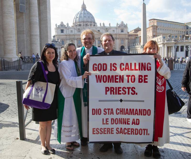 From right, Janice Sevre, Reverend Roy Bourgeois, Ree Hudson, Donna Rougeux and Erin Saizhanna, members of the Women's Ordination Conference group, stage a protest in front of  St. Peter's basilica in Rome, Monday, Oct. 17, 2011. A U.S. Catholic priest who supports ordination for women has been detained by police after marching to the Vatican to press the Holy See to lift its ban on women priests. The Rev. Roy Bourgeois and two supporters were taken away Monday in a police car after their group marched down the main boulevard leading to the Vatican and chanted outside St. Peter's Square "What do we want? Women priests!". (AP Photo/Andrew Medichini)