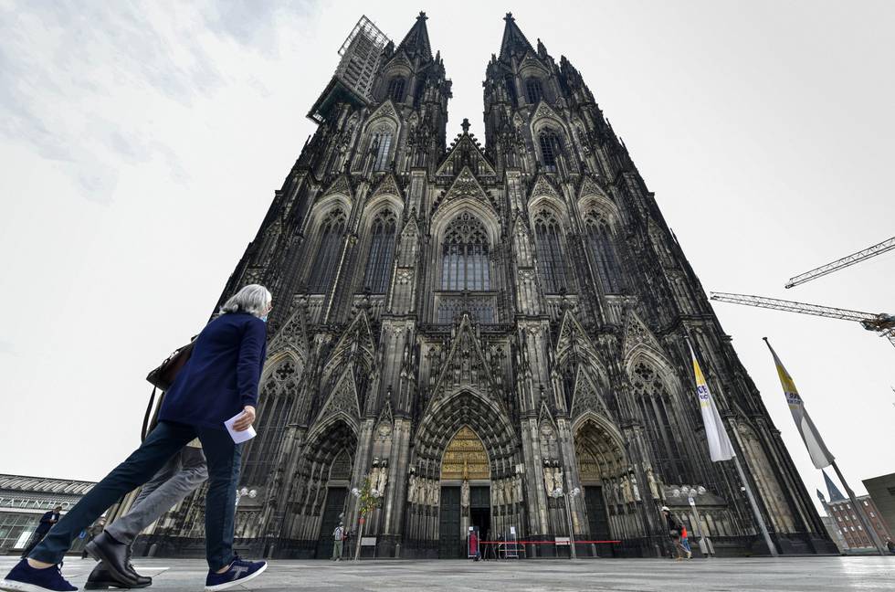 Kölnerdomen. Believers arrive with online tickets for the first church service at Germany's most famous Cologne Cathedral since the ban due of the coronavirus pandemic in Cologne, Germany, Sunday, May 3, 2020. Germany relaxed the lockdown and allowed limited church services with some hygienic and social distancing restrictions starting this weekend. (AP Photo/Martin Meissner)