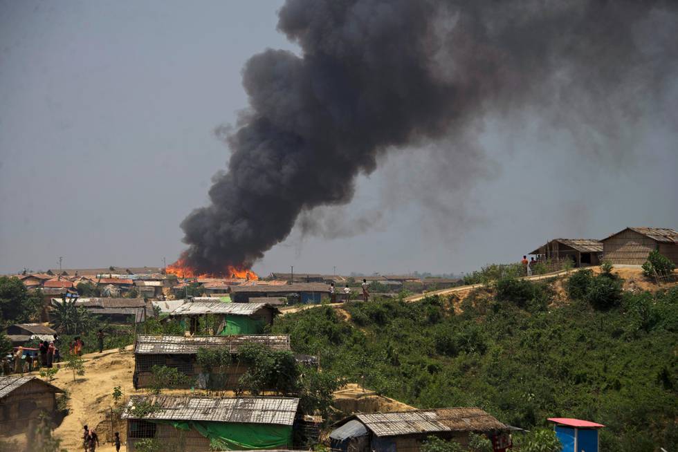 Smoke and flames rise from the site of a fire at  the Kutupalong refugee camp in Cox's Bazar, Bangladesh, Wednesday, April 24, 2019. A fire raced through a sprawling camp of Rohingya refugees in southern Bangladesh, destroying more than two dozen huts and a mosque on Wednesday, an official said. (AP Photo)