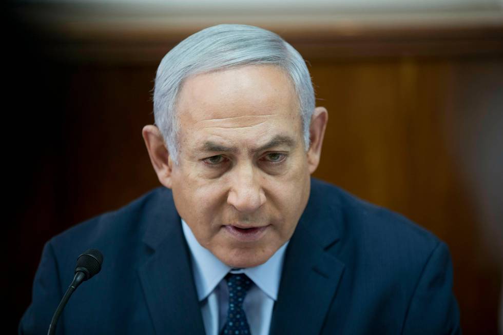 Israeli Prime Minister Benjamin Netanyahu chairs the weekly cabinet meeting at the prime minister's office, in Jerusalem, Sunday, Jan. 27, 2019. (Abir Sultan Pool via AP)
