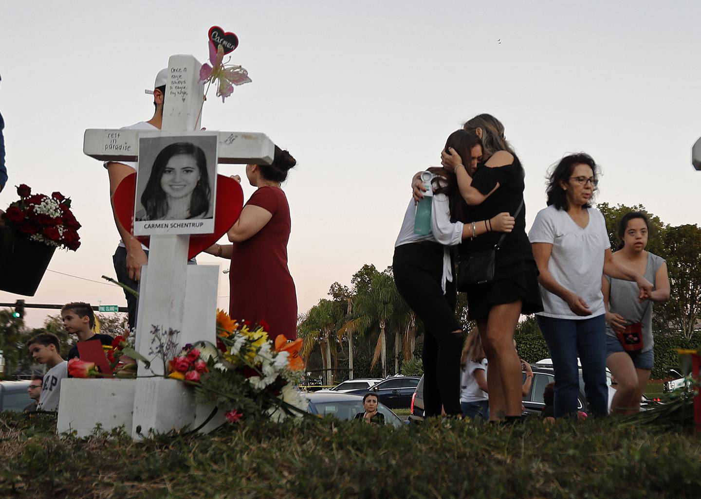 FILE - In this Feb. 18, 2018, file photo, Magaly Newcomb, right, comforts her daughter Haley Newcomb, 14, a student at Marjory Stoneman Douglas High School, at a memorial outside the school in Parkland, Fla. Its been more than 1,000 days since a gunman with an AR-15 rifle burst into the school, killing 17 people and wounding 17 others. And yet, with Valentines Day on Sunday, Feb. 14, 2021, marking the three-year milestone, Nikolas Cruzs death penalty trial is in limbo. (AP Photo/Gerald Herbert, File)