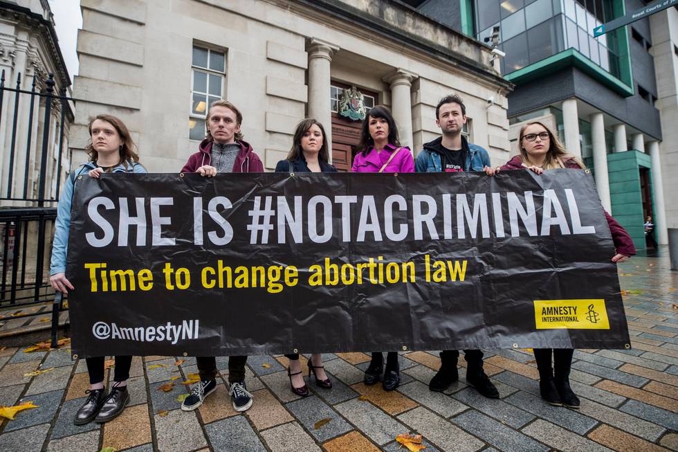 Solicitor Jemma Conlon (left centre) and Amnesty International Northern Ireland campaign manager, Grainne Teggart (right centre), with pro-choice campaigners holding a banner.