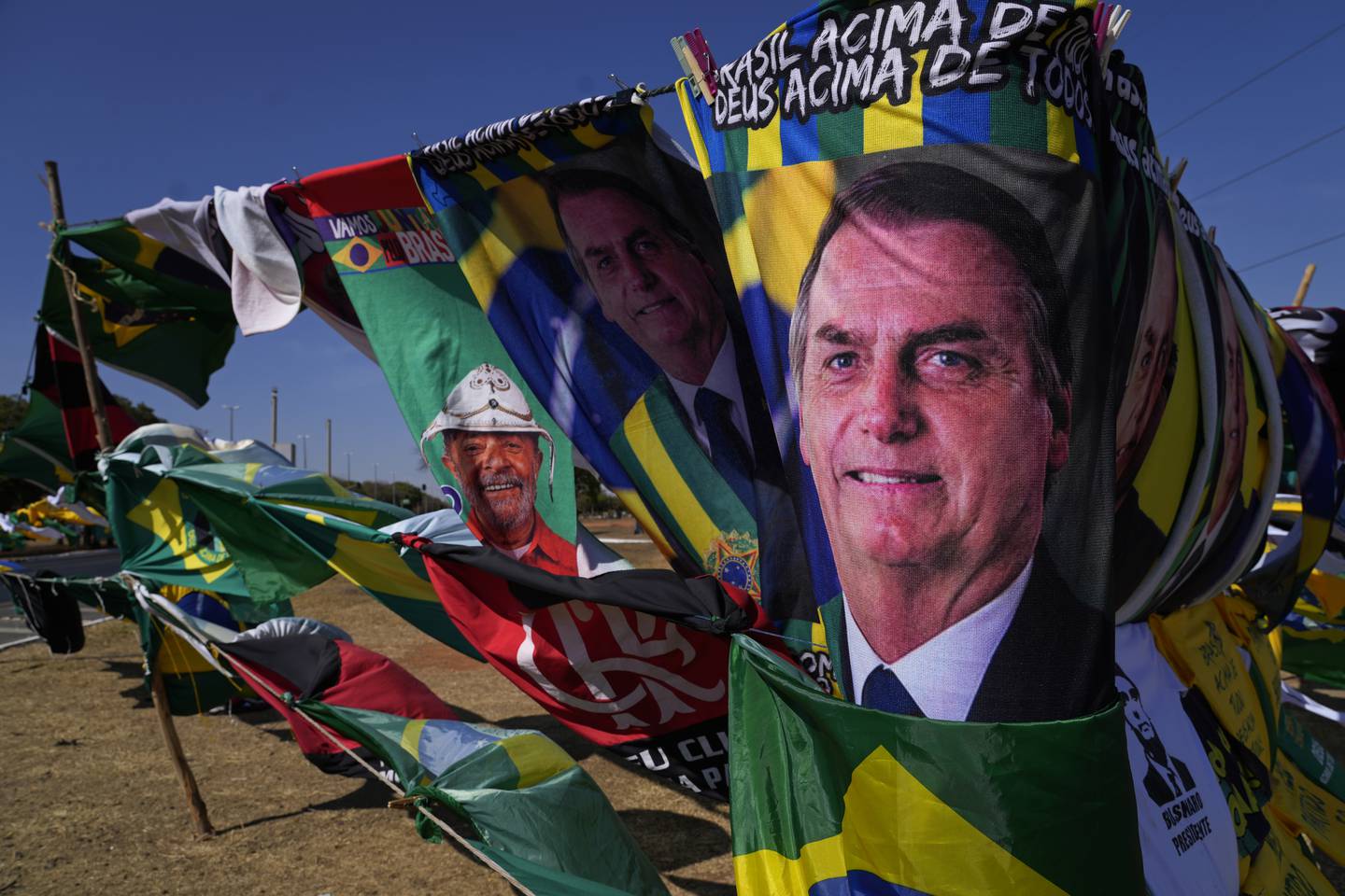 FULL GANG: Valgkampen er i full gang i Brasil, der flagg viser ansiktene til sittende president Jair Bolsonaro, (foran), og tidligere president Luiz Inacio Lula da Silva. Da Silva leder fortsatt klart på meningsmålingene, men Bolsonaro har økt sin oppslutning den siste tiden. Første runde avholdes 2. oktober, andre runde 30. oktober. Foto: Eraldo Peres / AP / NTB