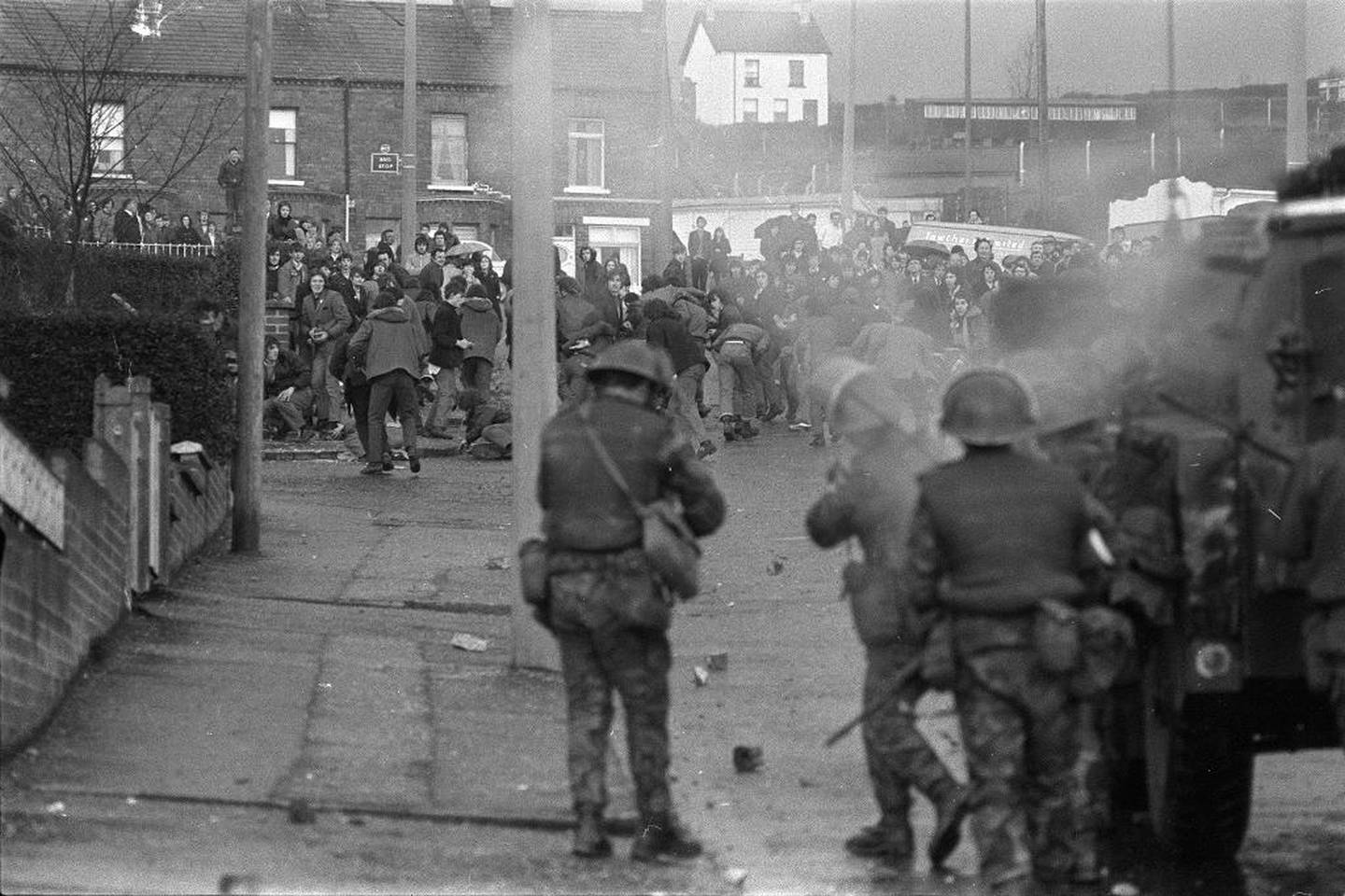 British troops fire rubber bullets at stone-throwing Protestant rioters who had set fire to the mobile classrooms of Our Lady of Mercy Secondary School in the Ballysillian area of west Belfast, Northern Ireland, March 28, 1972. (AP Photo/Michel Lipchitz)