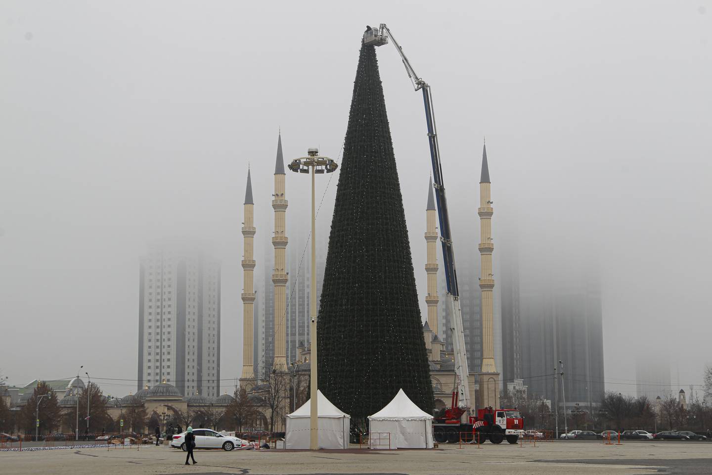 A giant Christmas tree is installed with the main Mosque and skyscrapers in the background, for Festivities celebrations in downtown Grozny, the capital of Chechnya, southern Russia, Tuesday, Dec. 7, 2021. (AP Photo/Musa Sadulayev)