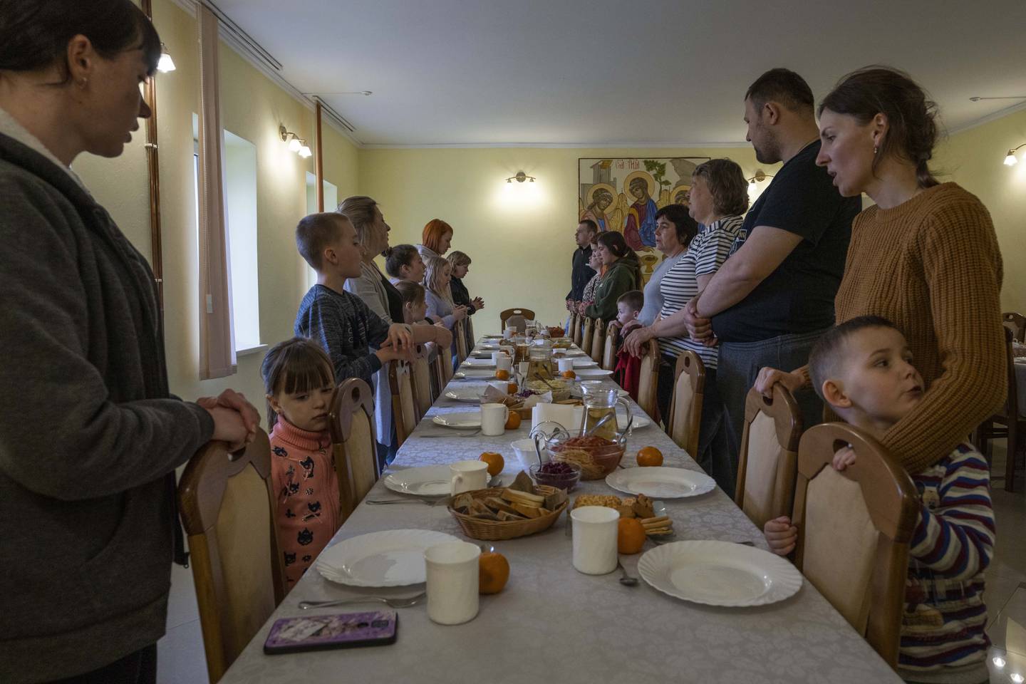 Internt fordrevne ukrainere ber for maten. Rundt 40 mennesker er innkvartert i klosteret, hvorav cirka tolv er barn. Foto: Nariman El-Mofty / AP / NTB