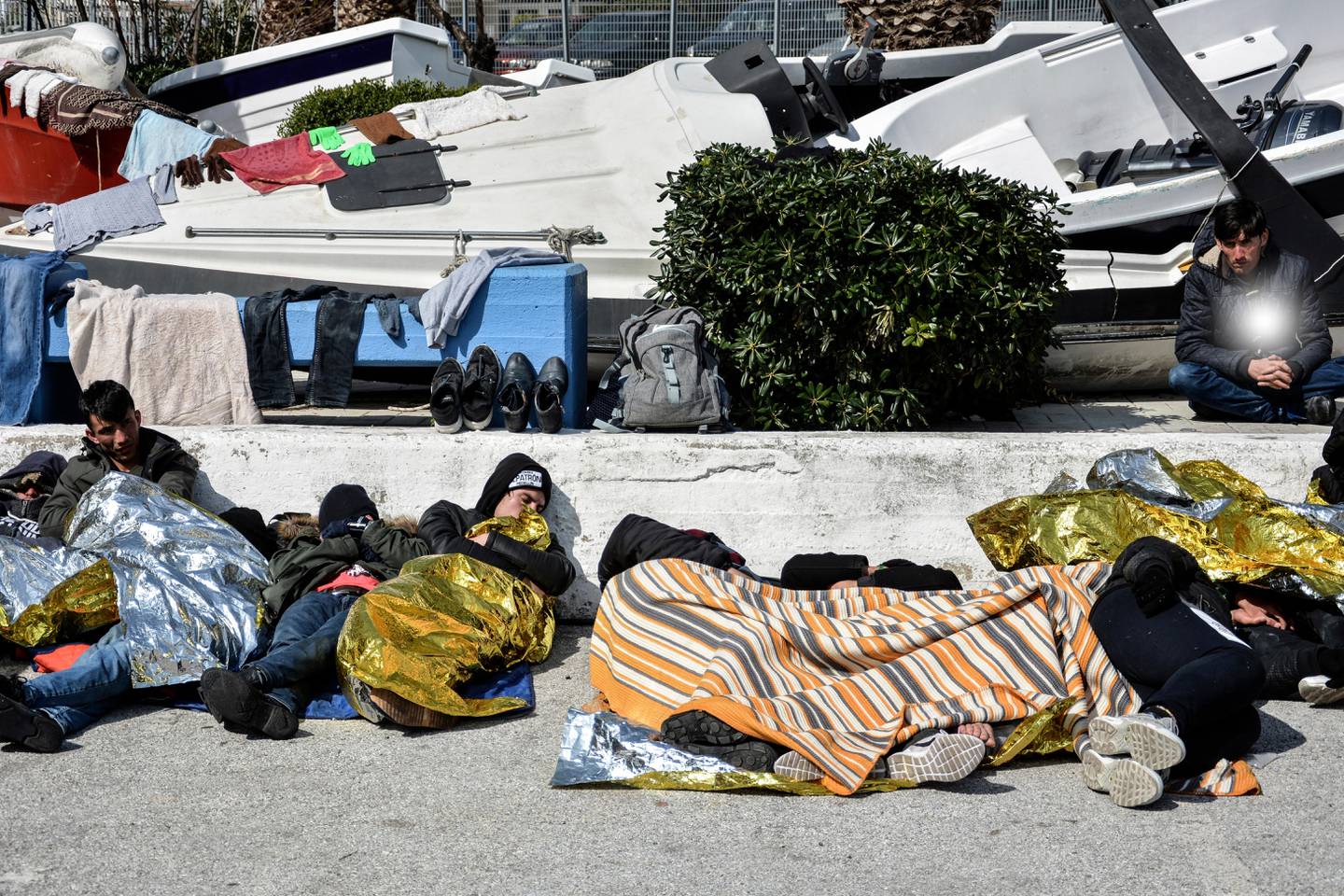 Migrants camp out at the port of Mytilene after locals block access to the Moria refugee camp, on the northeastern Aegean island of Lesbos, Greece, on Tuesday, March 3, 2020. Migrants and refugees hoping to enter Greece from Turkey appeared to be fanning out across a broader swathe of the roughly 200-kilometer-long land border Tuesday, maintaining pressure on the frontier after Ankara declared its borders with the European Union open. (AP Photo/Panagiotis Balaskas)