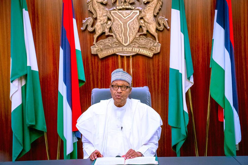 In this photo released by the Nigeria State House, Nigeria's President Muhammadu Buhari, address the nation on a live televised broadcast, Thursday, Oct. 22, 2020. Buhari has spoken to the nation about the unrest that has gripped the country in recent days but without mentioning the shootings of peaceful protesters at Lekki toll plaza on Tuesday night that prompted international outrage. (Bayo Omoboriowo/Nigeria State House via AP)