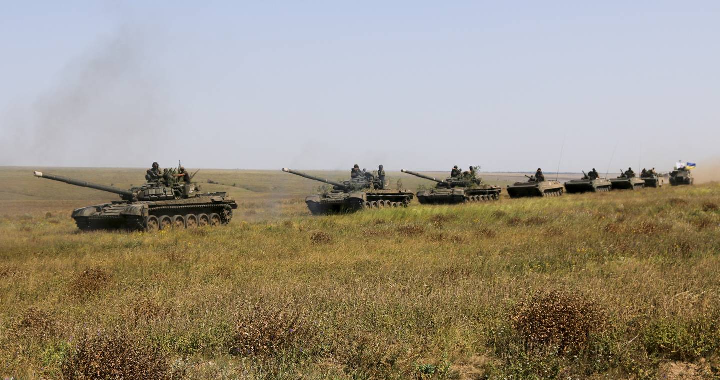 A column of Ukrainian tanks and APCs move towards the de-facto border with Crimea near Kherson, southern Ukraine, Friday, Aug. 12, 2016. Ukraine put its troops on combat alert Thursday along the country's de-facto borders with Crimea and separatist rebels in the east amid an escalating war of words with Russia over Crimea. (AP Photo/Aleksandr Shulman)