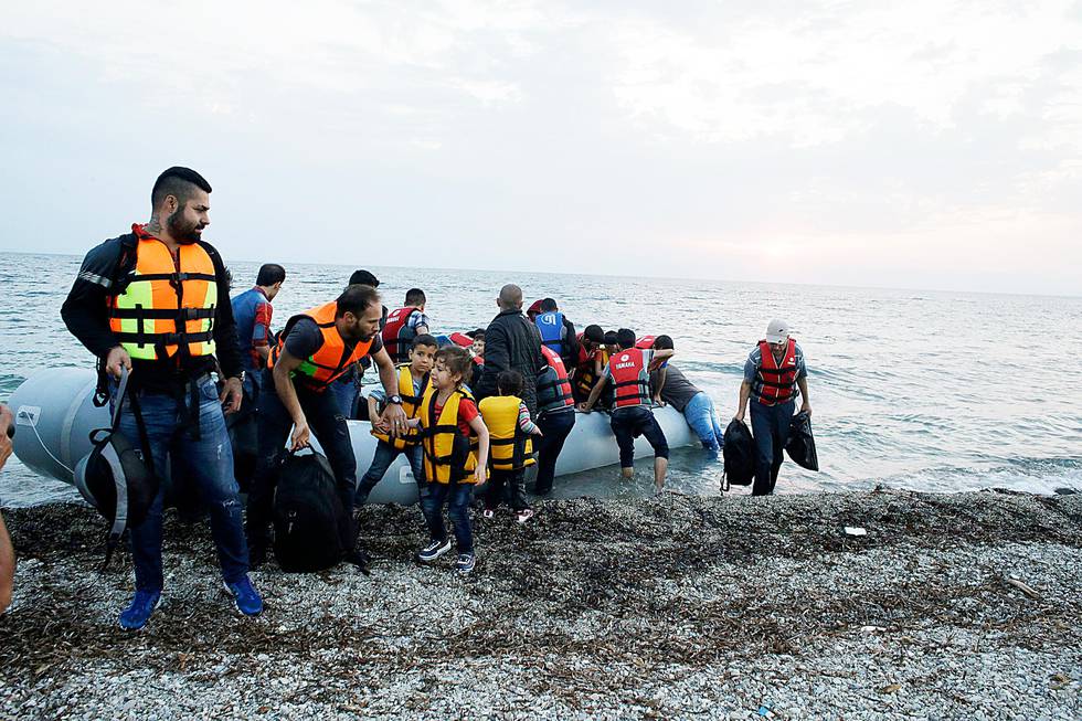 Syrian migrants arrive with an overcrowded dinghy from Turkish coasts at a Mytilene beach, on the northeastern Greek island of Lesvos, early Thursday, June 18, 2015. Around 100,000 migrants have entered Europe so far this year, with some 2,000 dead or missing during their perilous quest to reach the continent. Italy and Greece have borne the brunt of the surge, with many more migrants expected to arrive from June through to September. (AP Photo/Thanassis Stavrakis)