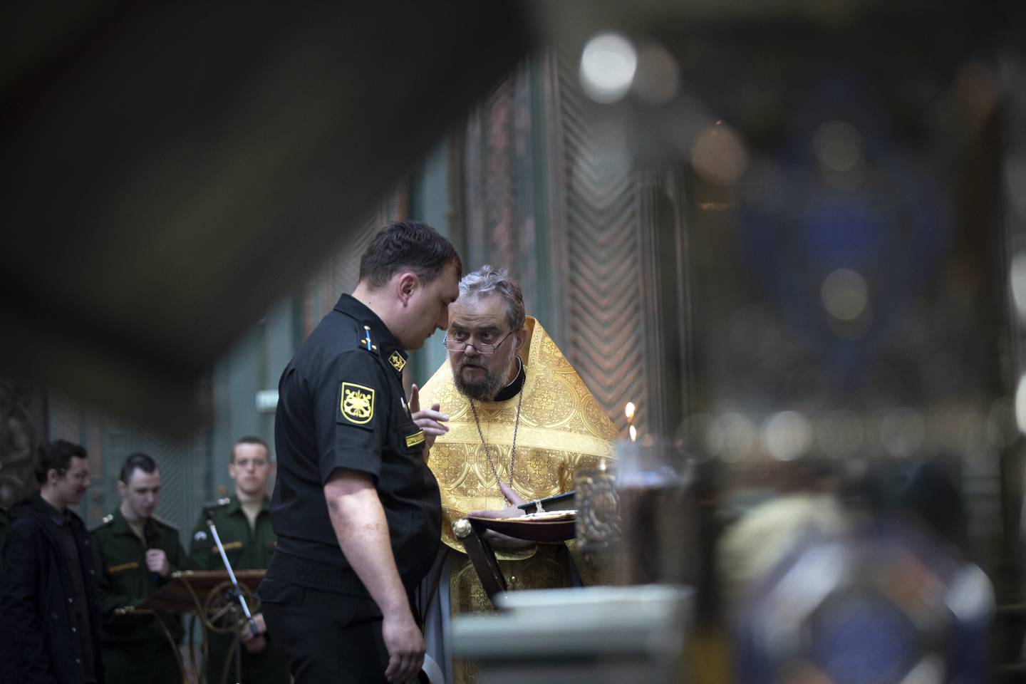 An Orthodox priest speaks to a Russian navy officer at the newly-built main cathedral of the Russian military in the Patriot Park outside in Moscow, Russia, Tuesday, June 23, 2020. The opening of the cathedral that was built in just under 600 days was timed to coincide with the 75th anniversary of the end of World War II in Europe. (AP Photo/Alexander Zemlianichenko)
