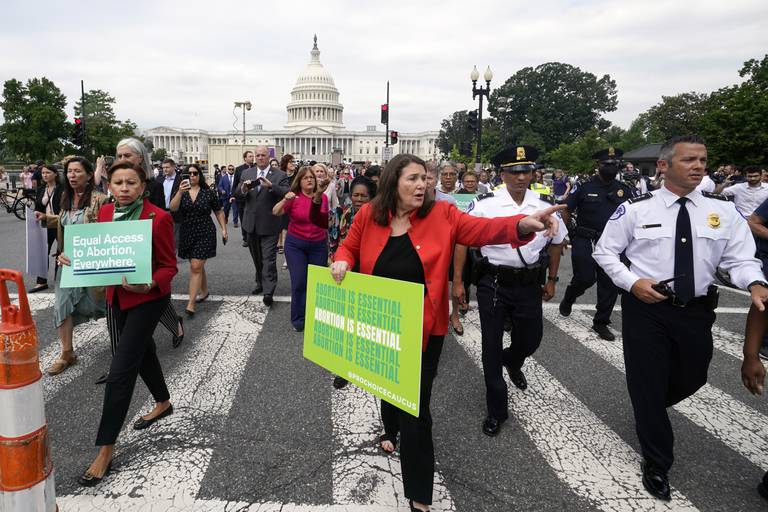 Members of the House of Representatives walk from the Capitol to the Supreme Court to protest the abortion decision, Friday, June 24, 2022. (AP Photo/Steve Helber)