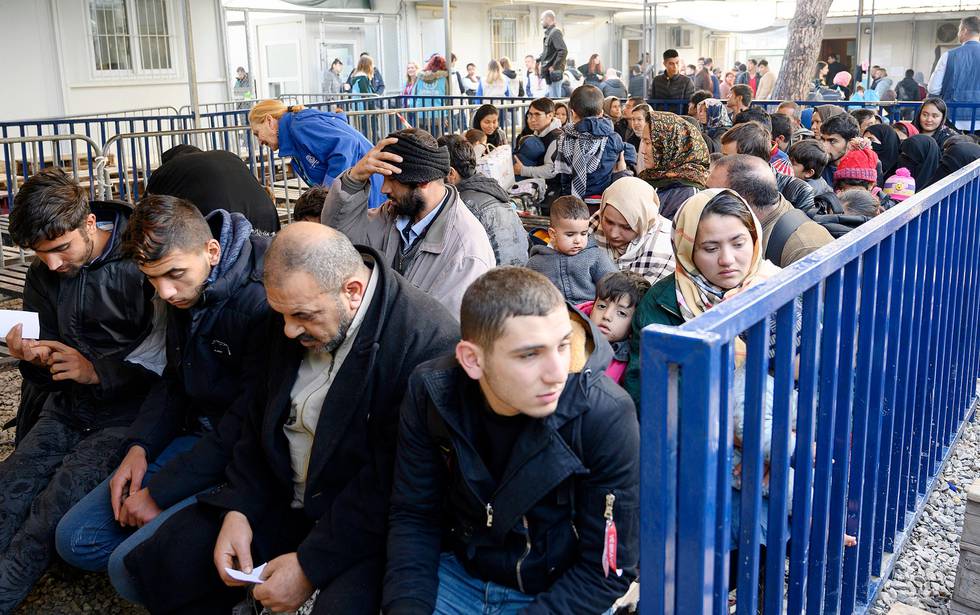 Newly arrived migrants wait to be seen by authorities at Moria refugee camp on the northeastern Aegean island of Lesbos, Greece, Wednesday, Nov. 27, 2019. Last week Greece's conservative government announced plans to overhaul the country's migration management system, replacing existing open camps on the islands with detention facilities and moving 20,000 asylum seekers to the mainland over the next few weeks. (AP Photo/Ignatis Tsiknis)