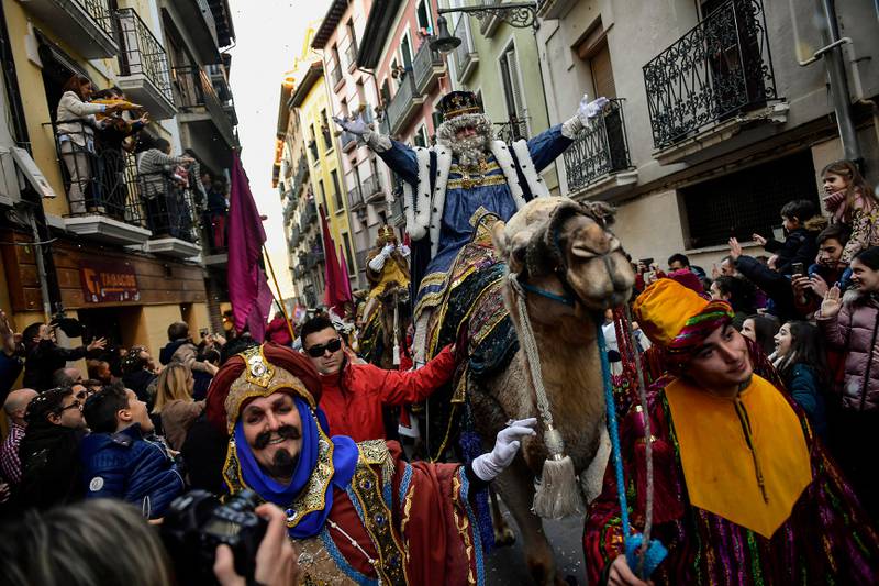 One king of The Cabalgata Los Reyes Magos (Cavalcade of the three kings) waves to people gathered in the old city during the cavalcade the day before Epiphany, in Pamplona, northern Spain, Sunday, Jan. 5, 2020. The parade symbolizes the coming of the Magi to Bethlehem following the birth of Jesus, marked in Spain and many Latin American countries Epiphany is the day when gifts are exchanged. (AP Photo/Alvaro Barrientos)