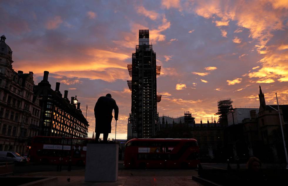 The sun rises as seen in Parliament Square with the statue of former Prime Minister Winston Churchill in the foreground in London, Wednesday, Nov. 14, 2018. British Prime Minister Theresa May will try to persuade her divided Cabinet on Wednesday that they have a choice between backing a draft Brexit deal with the European Union or plunging the U.K. into political and economic uncertainty. (AP Photo/Matt Dunham)