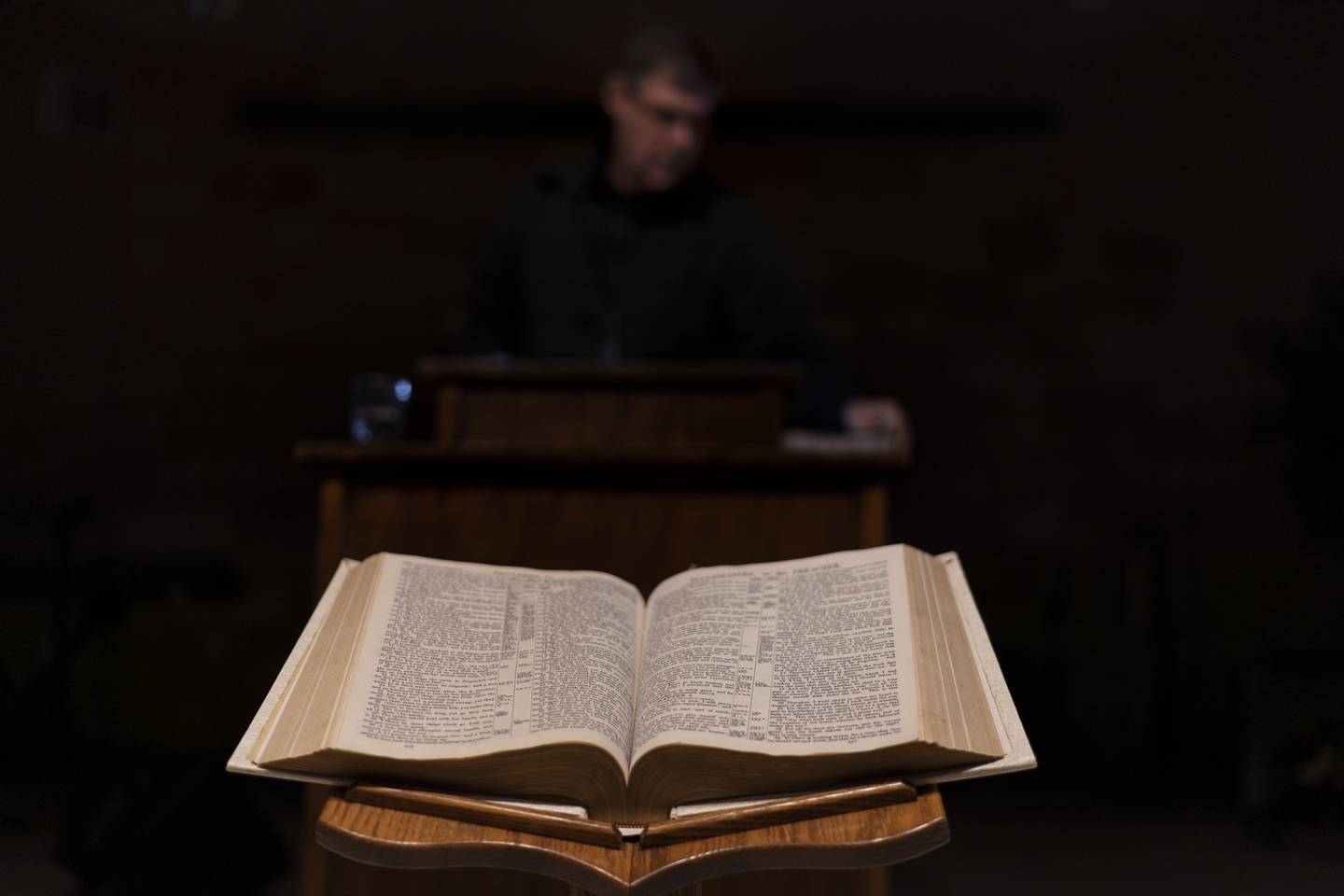 A Bible sits open as Pastor Rick Mannon stands at the pulpit at Calvary Assembly of God in Wilson, Wis., Wednesday, Nov. 16, 2022. Mannon's church is an outpost in the culture wars tearing at America, and a haven for people who feel shoved aside by a changing nation. Homosexuality is seen as dangerous here. Abortion is evil. The specter of one-world government looms. "If Christians don't get involved in politics, then we shouldn't have a say," Mannon says. "We can't just let evil win." (AP Photo/David Goldman)