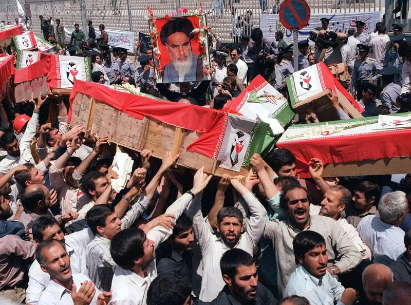 Mourners carry coffins through the streets of Tehran on Thursday, July 7, 1988 during a mass funeral four days after the warship USS Vincennes shot down Iran Air Flt. 655 over the Persian Gulf, killing all 290 people aboard.  (AP Photo)
