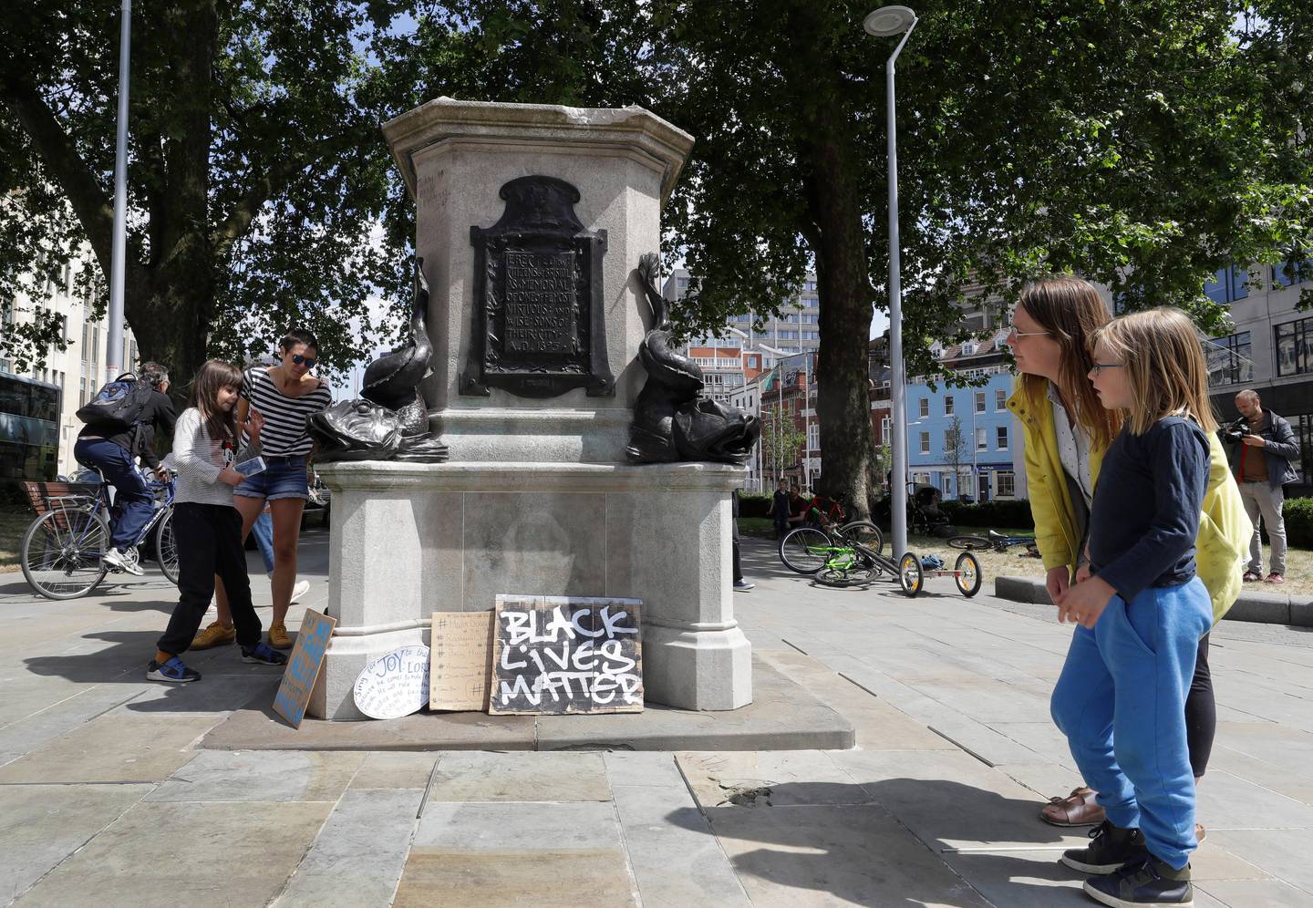 People look at the pedestal of the toppled statue of Edward Colston in Bristol, England, Monday, June 8, 2020, following the downing of the statue on Sunday at a Black Lives Matter demo. The toppling of the statue was greeted with joyous scenes, recognition of the fact that he was a notorious slave trader  a badge of shame in what is one of Britains most liberal cities. (AP Photo/Kirsty Wigglesworth)