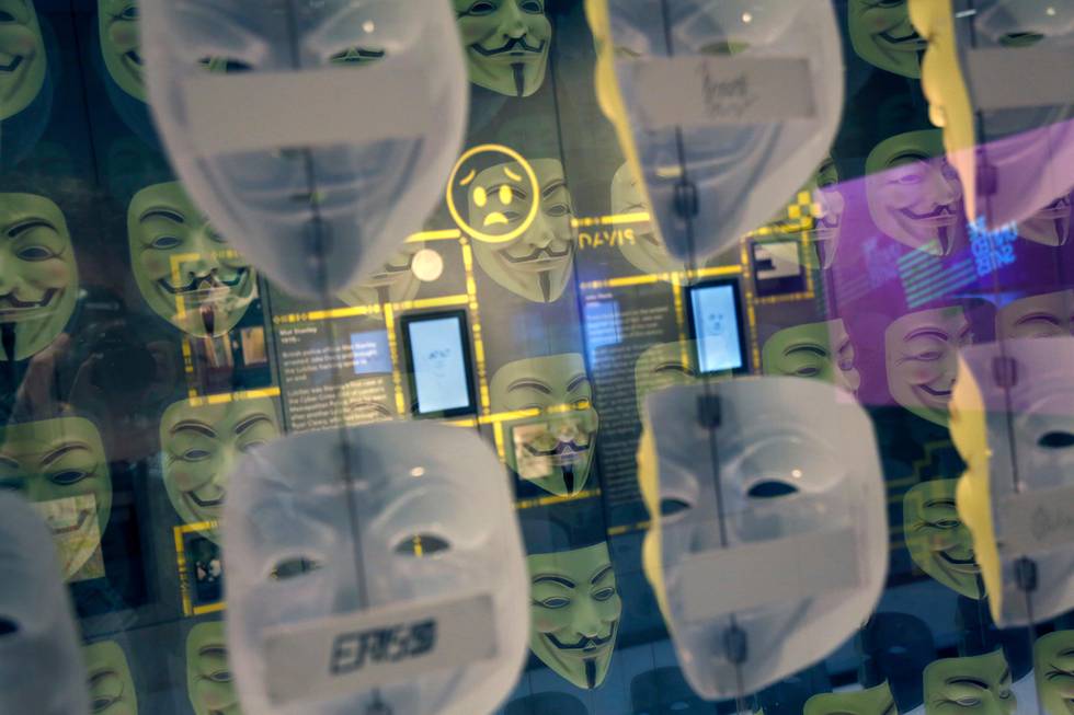 In this Monday, Feb. 12, 2018 photo, Guy Fawkes masks, often associated with the hacker group Anonymous, are displayed in a section about hacking at SPYSCAPE in New York. Visitors to a new attraction opening in New York City can learn about the elements of spying, its history and find out what kind of spy they could be. SPYSCAPE opens Friday. (AP Photo/Seth Wenig)
