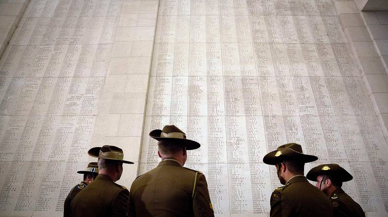 Australian soldiers look up at the names of World War I missing engraved on the Menin Gate in Ypres, Belgium, Monday, Nov. 5, 2018. (AP Photo/Virginia Mayo)