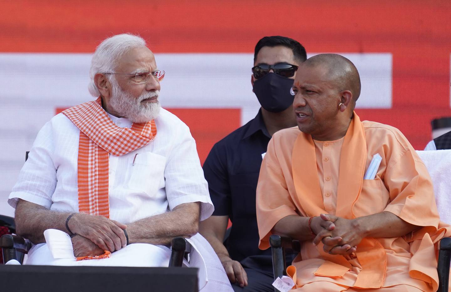 Indian Prime Minister Narendra Modi speaks with Yogi Adityanath during the swearing-in-ceremony of the latter as the Chief Minister of Uttar Pradesh state in Lucknow, India. Friday, March 25, 2022. (AP Photo/Rajesh Kumar Singh)