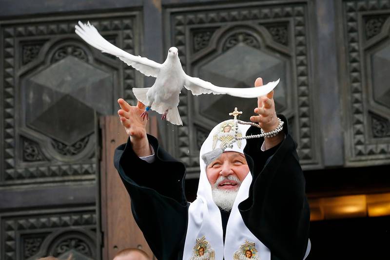 Russian Orthodox Church Patriarch Kirill releases a bird celebrating the Annunciation, on the eve of Orthodox Easter at the Christ the Savior Cathedral in Moscow, Russia, Saturday, April 7, 2018. Eastern Orthodox churches, which observe the ancient Julian calendar, usually celebrate Easter later than Western churches. (AP Photo/Alexander Zemlianichenko)