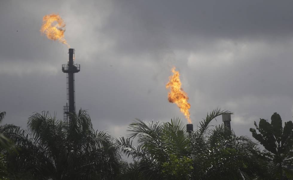 Gas flares belonging to the Agip Oil company are seen across farmland in Idu, Niger Delta area of Nigeria, Friday, Oct. 8, 2021. (AP Photo/Sunday Alamba)