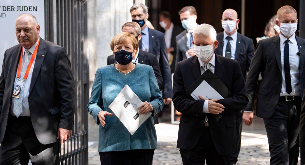 Chancellor Angela Merkel and Josef Schuster, President of the Central Council of Jews in Germany, leave the courtyard of the New Synagogue after the ceremony to mark the 70th anniversary of the Central Council of Jews in Berlin, Germany, Tuesday, Sept. 15, 2020. The Central Council of Jews in Germany was founded on 19 July 1950 in Frankfurt am Main. (Bernd von Jutrczenka/Pool via AP)