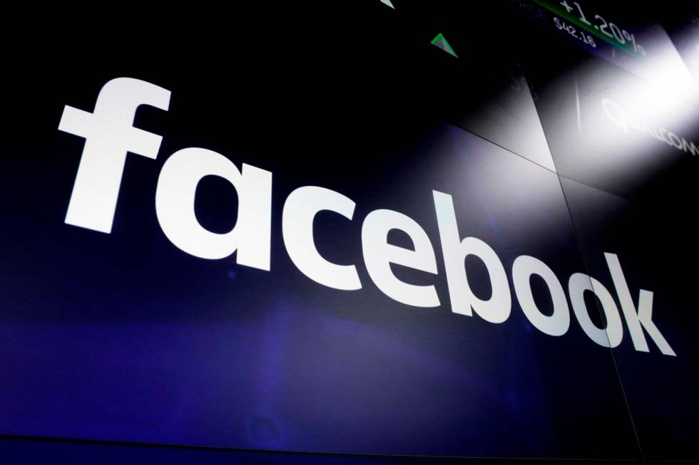 FILE - In this March 29, 2018, file photo, the logo for Facebook appears on screens at the Nasdaq MarketSite in New York's Times Square. A Facebook official says the social media platform is shutting down a series of fake news sites spreading false information about the Bangladesh opposition days before national elections. (AP Photo/Richard Drew, File)