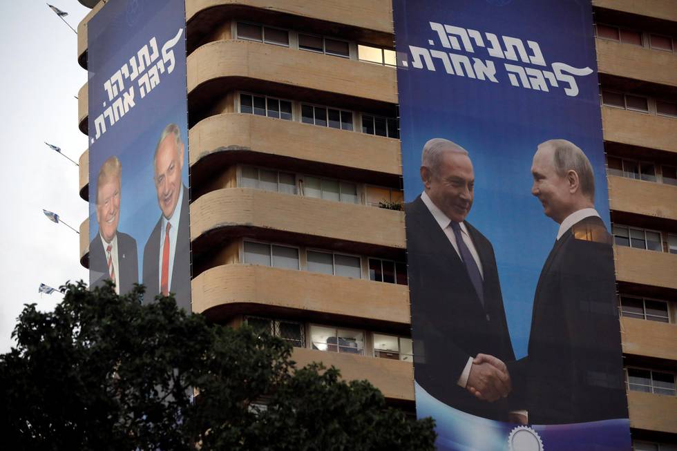 Giant banners of Israeli Prime Minister Benjamin Netanyahu shaking hands with Russian President Vladimir Putin and U.S. President Donald Trump are hung on the Likud's party headquarters as part of the election campaign in Tel Aviv, Israel July 28, 2019. The words in Hebrew read, "Netanyahu, a different league." REUTERS/Nir Elias