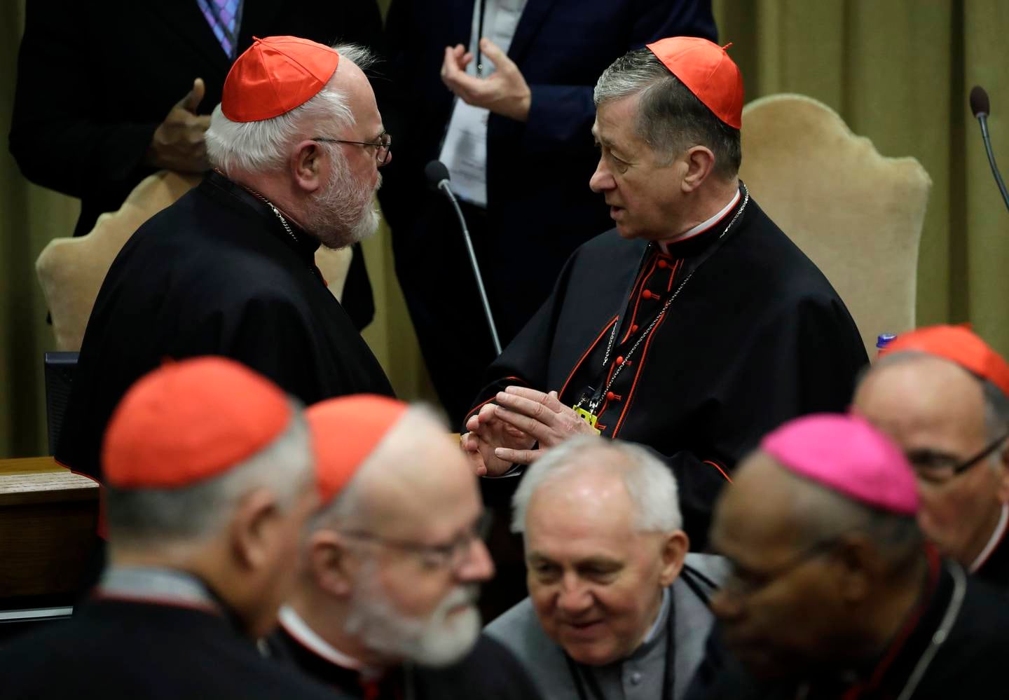 Chicago Archbishop Cardinal Blase J. Cupich, right, talks with Cardinal Reinhard Marx, as they wait for the arrival of Pope Francis for the third day of a Vatican's conference on dealing with sex abuse by priests, at the Vatican, Saturday, Feb. 23, 2019. (AP Photo/Alessandra Tarantino, Pool)