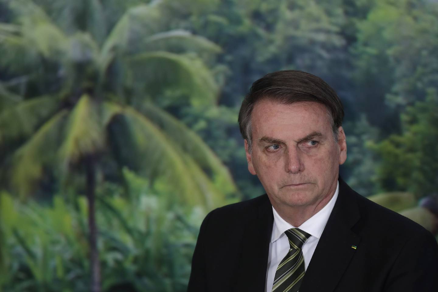 FILE - In this Oct. 1, 2019 file photo, President Jair Bolsonaro attends a ceremony to launch an agro program at the Planalto presidential palace in Brasilia, Brazil. Alter do Chao, a sleepy Amazon town, has become the flashpoint for the growing hostility between Bolsonaro and environmental groups following the arrest of firefighters he says set rainforest fires. (AP Photo/Eraldo Peres, File)