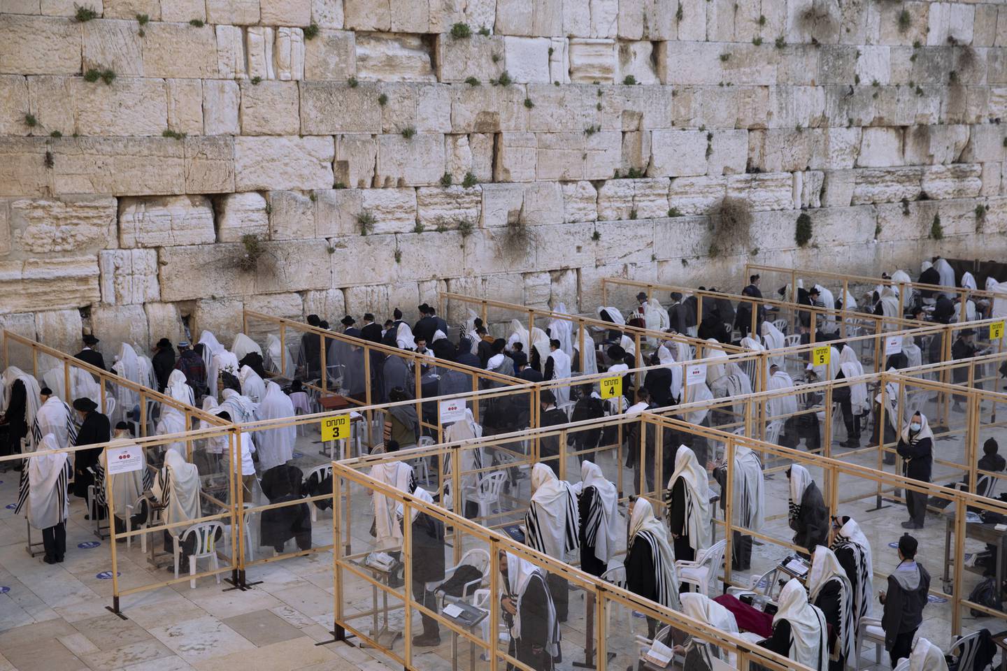 Ultra-Orthodox Jewish men pray in a divided section of the Western Wall, the holiest site where Jews can pray, in accordance with  government's measures to help stop the spread of the coronavirus, in Jerusalem's Old City, Monday, Feb. 8, 2021. (AP Photo/Oded Balilty)