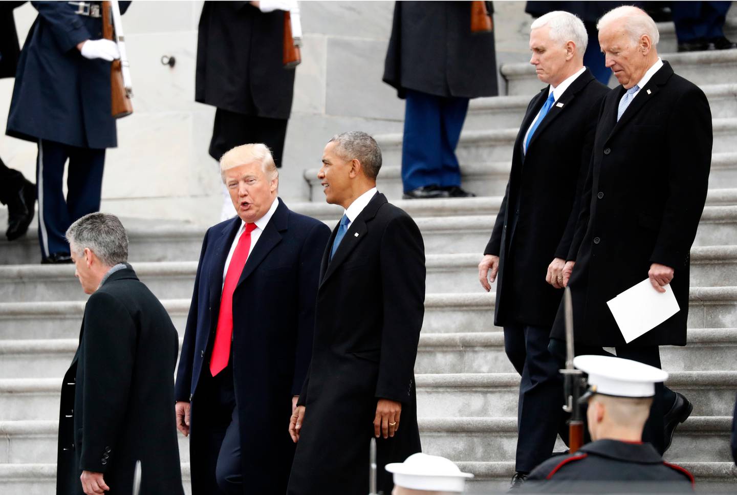 President Donald Trump walks with former President Barack Obama as Vice President Mike Pence walks with former Vice President Joe Biden as the Obamas and Bidens depart the East Front of the U.S. Capitol, Friday, Jan. 20, 2017 in Washington. (AP Photo/Alex Brandon)