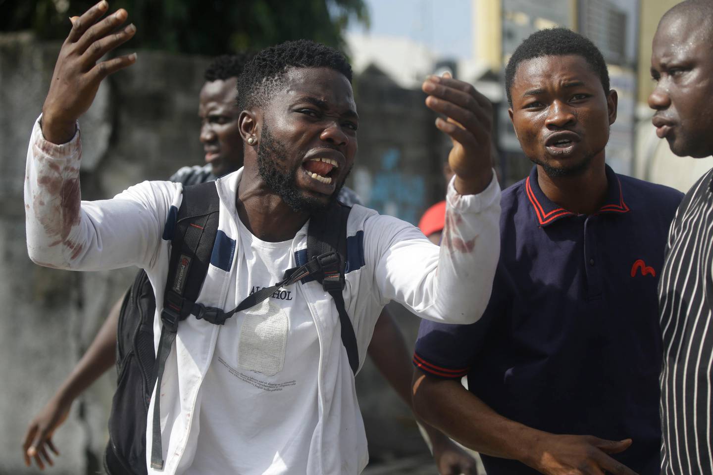 Alister, a protester who says his brother Emeka died from a stray bullet from the Army, reacts while speaking to Associated Press near Lekki toll gate in Lagos, Nigeria, Tuesday Oct. 20, 2020.  After 13 days of protests against alleged police brutality, authorities have imposed a 24-hour curfew in Lagos, Nigeria's largest city, as moves are made to stop growing violence. ( AP Photo/Sunday Alamba)