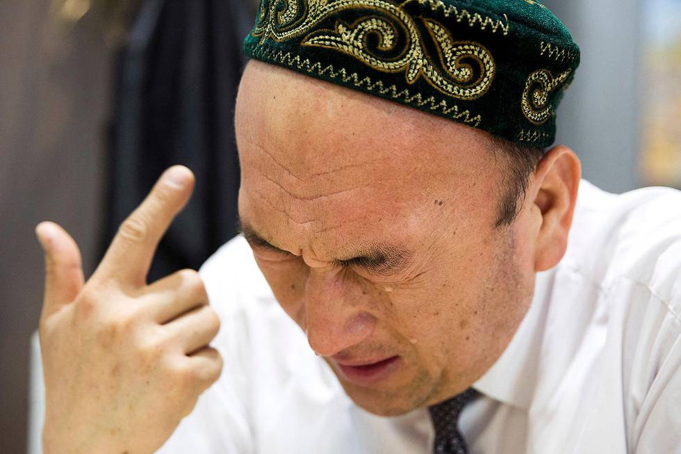In this March 29, 2018, photo, Omir Bekali cries as he details the psychological stress endured while in a Chinese internment camp during an interview in Almaty, Kazakhstan. Since 2016, Chinese authorities in the heavily Muslim region of Xinjiang have ensnared tens, possibly hundreds of thousands of Muslim Chinese, and even foreign citizens, in mass internment camps. The program aims to rewire detaineesÄô thinking and reshape their identities. Chinese officials say ideological changes are needed to fight Islamic extremism. (AP Photo/Ng Han Guan)