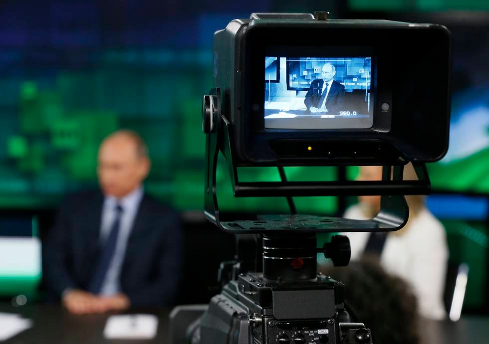 FILE - In this Tuesday, June 11, 2013 file photo, Russian President Vladimir Putin is shown on the screen of a camera viewfinder at the new headquarters of "Russia Today" television channel in Moscow, Russia. Major brands in the export division of Russian media include RT, the RIA Novosti news agency and its English-language arm Sputnik, and the Voice of Russia radio station. Despite the pounding Russias economy is taking from the slump in the price of crude oil and the Wests Ukraine-related sanctions, the annual government budget allocation for RT alone has been hiked by 30 percent since 2014, to the ruble equivalent of $289 million. (Yuri Kochetkov/Pool Photo via AP, File)