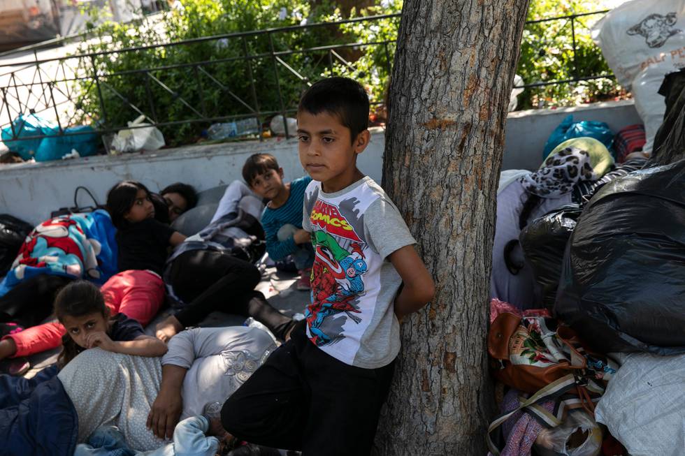 Afghan migrants camp with their families, following their arrival from Lesbos' Moria camp, on a central square of Athens, Sunday, June 14, 2020. Some migrants, whose asylum application has been approved, arrived on the country's mainland without having a place to stay. (AP Photo/Yorgos Karahalis)