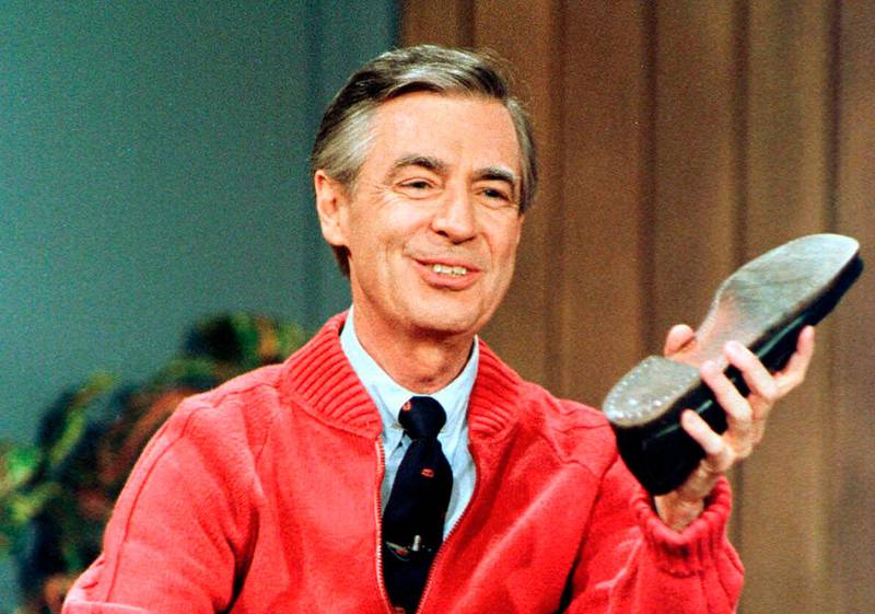 FILE - In this June 28, 1989, file photo, Fred Rogers rehearses for the opening of his PBS show "Mister Rogers' Neighborhood" during a taping in Pittsburgh. Authorities say a crew member working on a movie about Mister Rogers has died after he suffered an apparent medical emergency and fell two stories off a balcony Thursday, Oct. 11, 2018, during a break in filming in western Pennsylvania. (AP Photo/Gene J. Puskar, File)