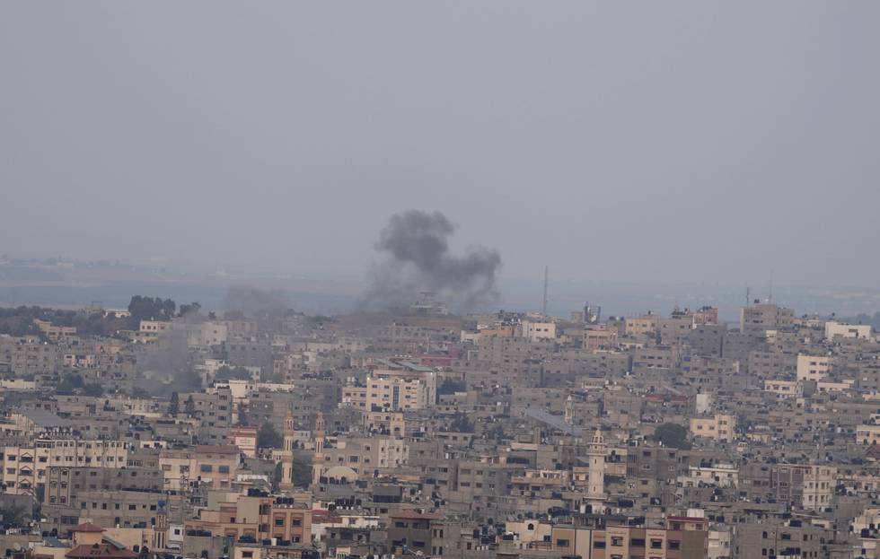 Røyk stiger opp fra en bygning som ble rammet av israelske luftangrep i Gaza by fredag. Foto: Hatem Moussa / AP / NTB