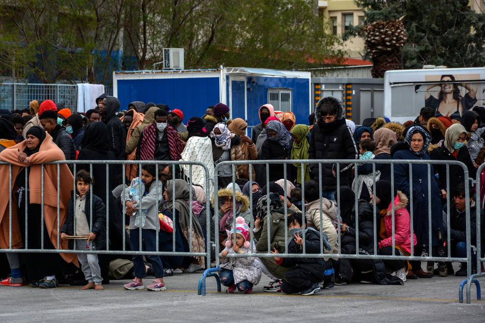 Migrants who camp out at the port of Mytilene after locals block access to the Moria refugee camp, wait to receive food and water by Greek authorities on the northeastern Aegean island of Lesbos, Greece, on Wednesday, March 4, 2020.Turkey made good on a threat to open its borders and send migrants into Europe last week. In the past few days hundreds of people have headed to Greek islands from the nearby Turkish coast in dinghies. (AP Photo/Panagiotis Balaskas)
