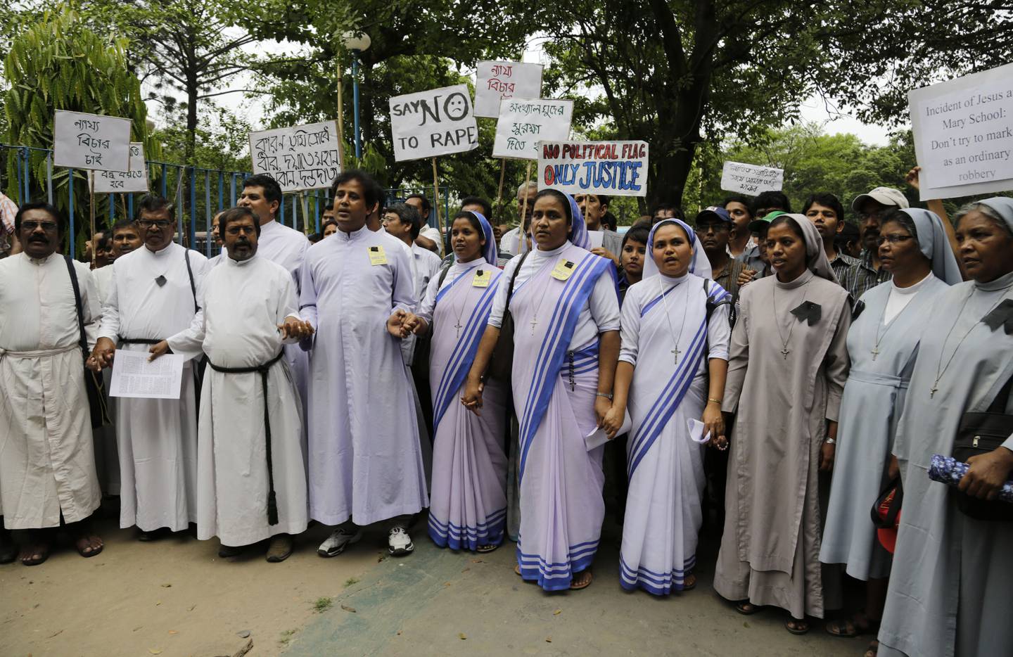 Christian nuns and priests participate in an all-religion silent rally protesting the rape of an elderly nun at a convent in Ranaghat, in Kolkata, India, Wednesday, March 18, 2015. A nun in her 70s was gang-raped by a group of bandits when she tried to prevent them from committing a robbery in the Convent of Jesus and Mary School in West Bengal state's Nadia district, according to police. (AP Photo/ Bikas Das)