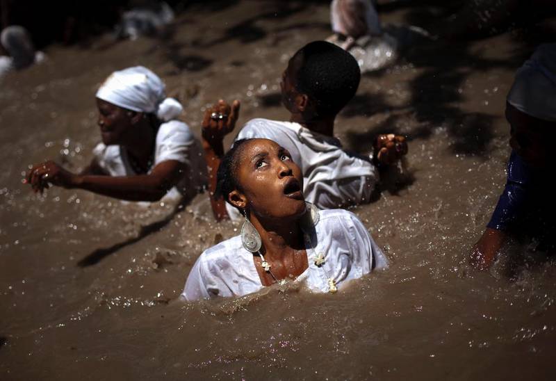 Mennesker svømmer i «hellig» vann i en voodoo-seremoni i Souvenance i Haiti påsken 2011. På denne måten viser de sin respekt for åndene.