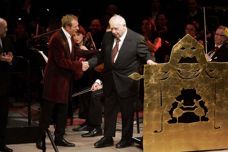 Entertainer Kurt Aeschbacher presented American literary critic and scholar Harold Bloom with  this year's 50,000 (US$65,175) Hans Christian Andersen Prize in Odense, Saturday, April 2, 2005.  Denmark celebrates the 200th birthday of Denmark's most beloved and famous author Hans Christian Andersen.  (AP Photo / Polfoto, Anders Brohus) DENMARK OUT