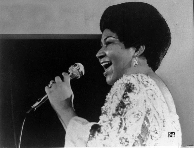 FILE - In this Jan. 28, 1972 file photo, vocalist Aretha Franklin sings a few notes into microphone.   Franklin died Thursday, Aug. 16, 2018 at her home in Detroit.  She was 76.  (AP Photo)