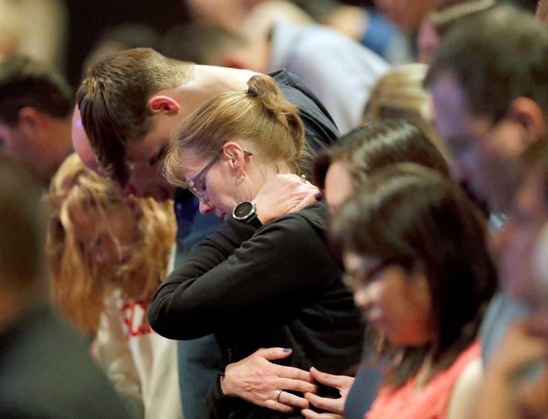 Audience members react as it was announced, Wednesday, Aug. 8, 2018, at Willow Creek Community Church in South Barrington, Ill., that lead pastor Heather Larson is stepping down, and the entire Board of Elders will do so by the end of the year. Larson said the church needed new leadership in the wake of sexual harassment allegations against church founder Bill Hybels. (Steve Lundy/Daily Herald via AP)