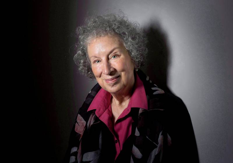 FILE - In this June 9, 2015 file photo, author Margaret Atwood poses to promote her novel, "The Heart Goes Last" in Toronto. The Canadian author has provided additional material for a special audio edition of "The Handmaid?Äôs Tale,?Äù coming out next week exclusively from Audible.com. The audiobook expands upon a version released in 2012 and narrated by Claire Danes. Atwood?Äôs novel, as related through a handmaid known as ?ÄúOffred,?Äù imagines a dystopian society named Gilead in which women have lost their rights and even their identities. (Darren Calabrese/The Canadian Press via AP, File)