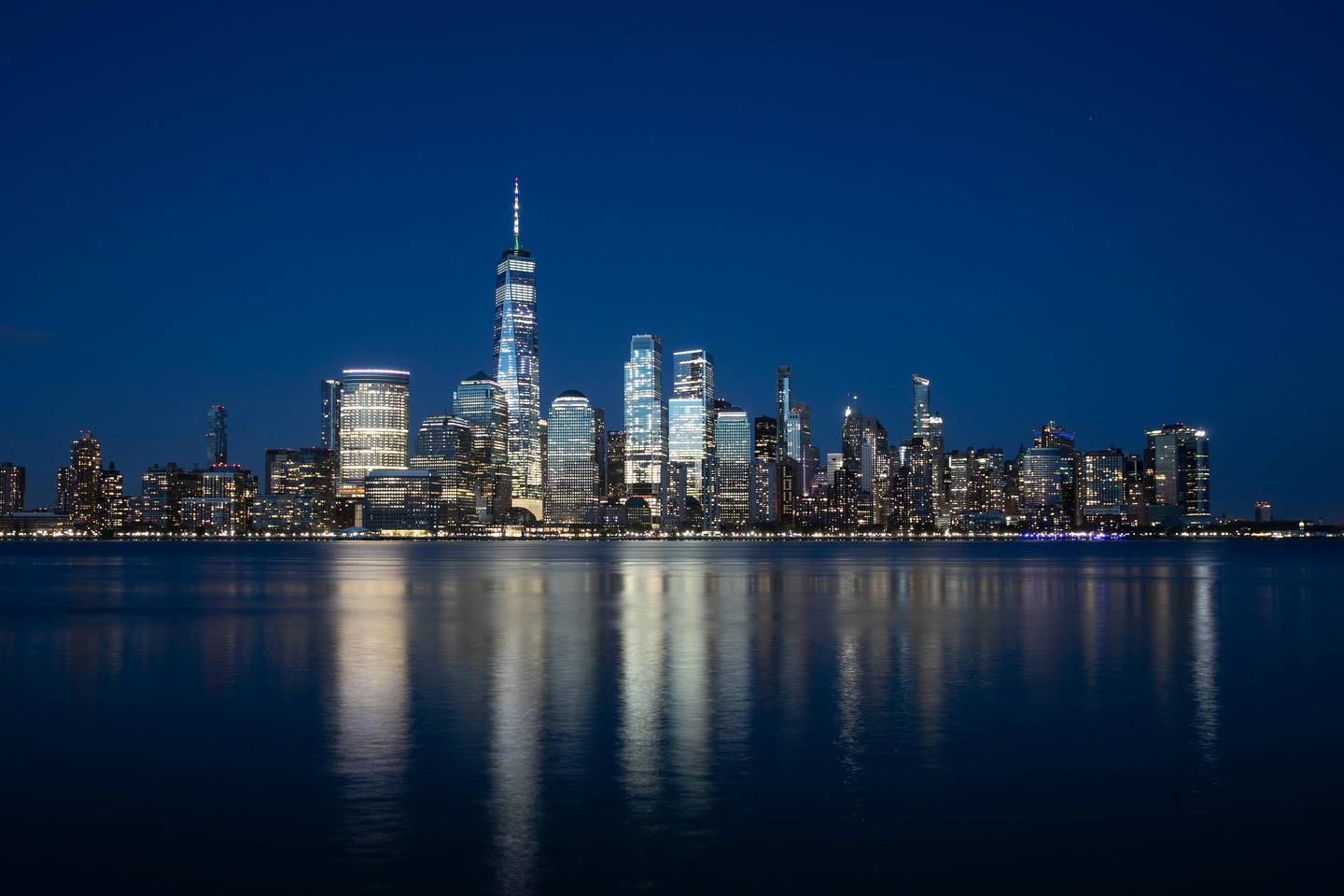The Manhattan skyline is seen from Jersey City, N.J., Tuesday night, April 28, 2020, during the coronavirus pandemic. At the time the photograph was taken the view was a quiet one: there were no boats or ships visible on the Hudson River and no airplanes or helicopters flying over the city. (AP Photo/Mark Lennihan)