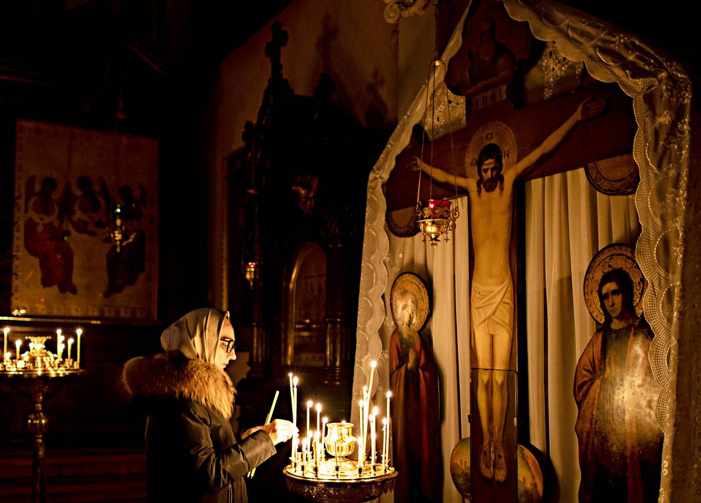 A Lithuanian Orthodox believer prays during the liturgy on Orthodox Christmas Eve in the Prechistensky, the Cathedral Palace in Vilnius, Lithuania, Monday, Jan. 6, 2020. Orthodox Christians celebrate Christmas on Jan. 7, in accordance with the Julian calendar. (AP Photo/Mindaugas Kulbis)